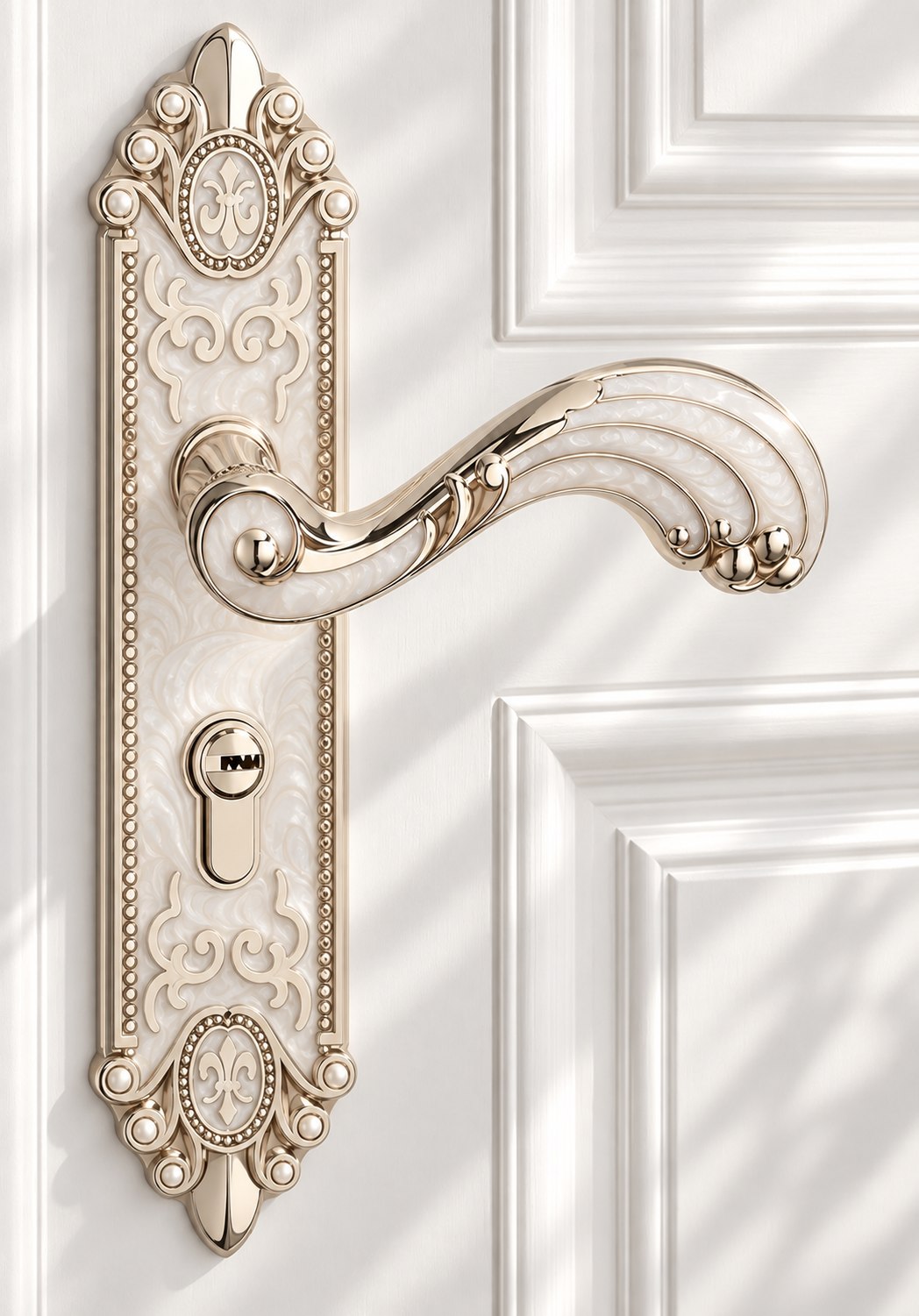 An ornate ivory and gold door handle on a white panelled door