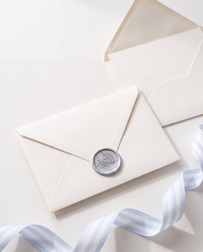Ivory envelope sealed with an Asti Media wax seal